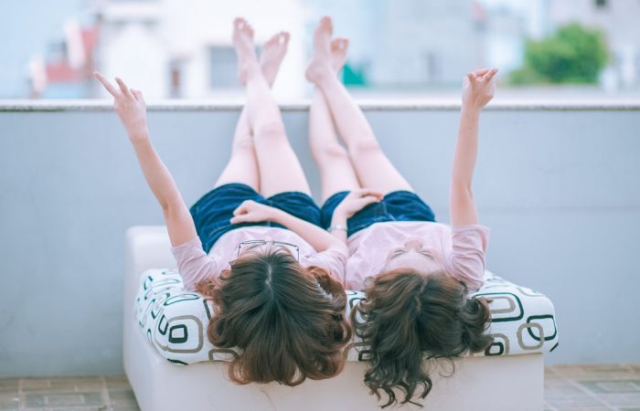 Friends sitting on bed