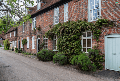 Row of brick cottages with ivy
